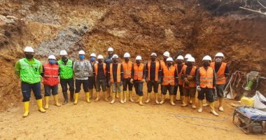 Workers standing in front of a copper porphyry cluster at Warintza project in Ecuador